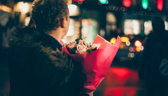 A guy holding flowers - Valentine's Day.