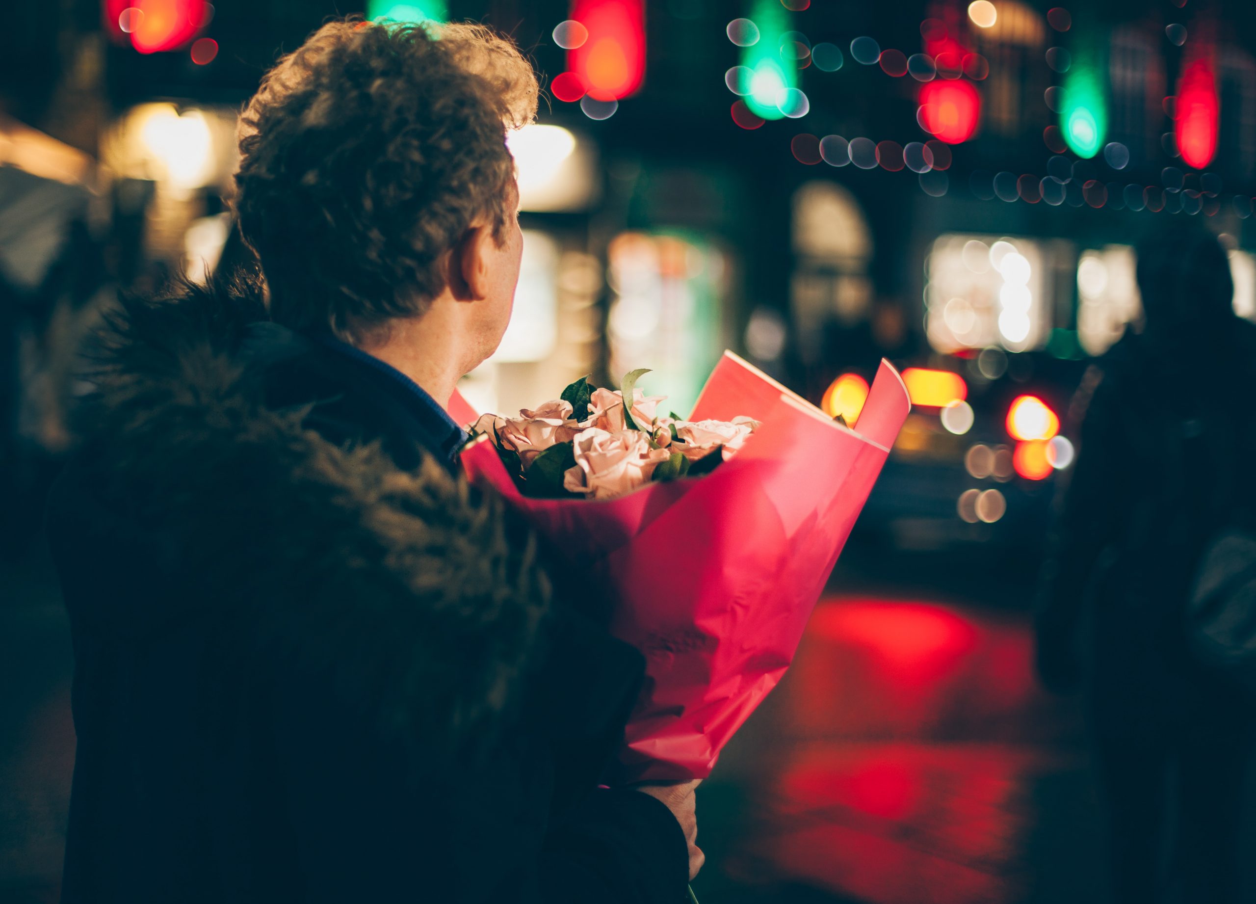 A guy holding flowers - Valentine's Day.